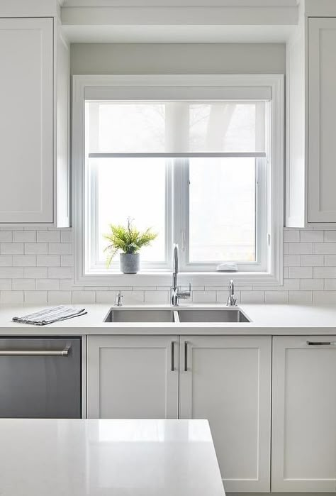 White subway tiles with light gray grout in kitchen featuring white shaker cabinets, nickel pulls and a stainless steel dual sink with a gooseneck faucet. Kitchen Window Backsplash, Tile Around Window, Light Gray Grout, Window Backsplash, 2023 Kitchen Remodel, Kitchen Tiling, White Subway Tile Kitchen, Herbs In The Kitchen, White Wood Paneling