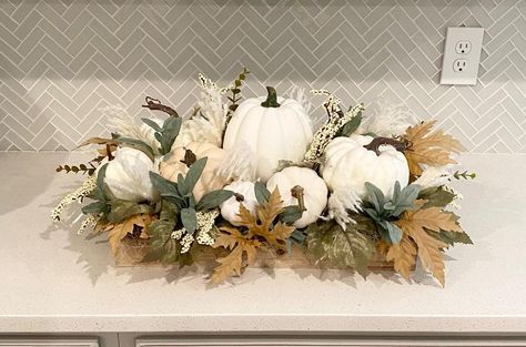 Beautiful large fall arrangement filled with white pumpkins, pampas grass, berries, sage, fall leaves and berries nestled in a wood tray. This custom piece adds a touch of fall to any room in your home. Also makes a great gift. Overall dimensions 22" long x 12" wide x 11" tall. Pumpkin Table Display, Diy Dough Bowl Centerpiece, Fall Flower Arrangements For Home, Fall Tablescapes Farmhouse, Fall Decor Coffee Table, White Fall Decor, Orange Fall Decor, White Pumpkin Centerpieces, Pumpkin Flowers