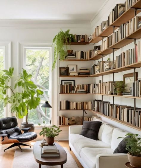 Long Wall Bookshelves, Bookcase Around Sofa, Bookcase Wall Behind Sofa, Small Living Room With Storage, Bookshelf Wall With Window, Couch With Bookcase Behind It, Bookshelves Above Couch, Tall Bookshelves Living Room, Bookshelf Behind Sofa