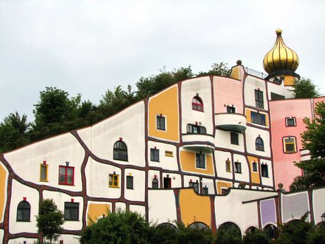 To say Austrian artist and architect Hundertwasser was eccentric is something of an understatement. Remembered today as a proponent of letting mold grow freely in the home and of abolishing the modern toilet, Hundertwasser was born in 1928 in Vienna as Friedrich Stowasser. He began signing his work Hundertwasser after World War II, when he pursued art at the Academy of Fine Arts in Vienna and travelled across Europe and Africa, developing his perspective along the way. Hundertwasser Architecture, Hundertwasser Art, Unusual Buildings, Unusual Homes, Architecture Inspiration, Interesting Buildings, Amazing Buildings, Unique Buildings, Sustainable Architecture