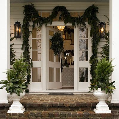 Some simple porch planters and a casually draped garland framing the doorway are festive and creative. | Community Post: Subtle And Elegant Decorating Tips To Help You Transition From Halloween To Christmas To New Years Southern Living Christmas, Christmas Entryway, Southern Christmas, Porch Planters, Vintage Inspired Christmas, Christmas Porch, Noel Christmas, Vintage Christmas Decorations, Christmas Love