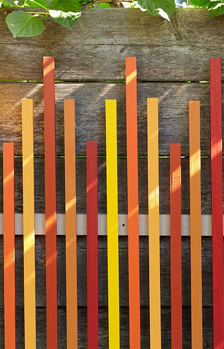 Turn a dull wooden fence into a backdrop for this colorful work of art you can make in a weekend. It also works as indoor wall art. Yellow Fence, Screened Room, Yard Edging, Hanging Sculpture, Horizontal Fence, Diy Fence, Backyard Landscape, Outdoor Room, Garden Plans