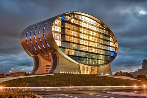 Mauritius Commercial Bank in Quatre Bornes https://archnet.org/sites/7003 is an ‘ellipse’ shaped building covered in an 'aluminium-clad concrete shell'.  Jean François Koenig Architects. #ArchnetAZ #bank Ellipse Architecture, Port Louis, Office Table Design, Film Locations, Commercial Bank, Amazing Buildings, Filming Locations, Architectural Design, Contemporary Architecture