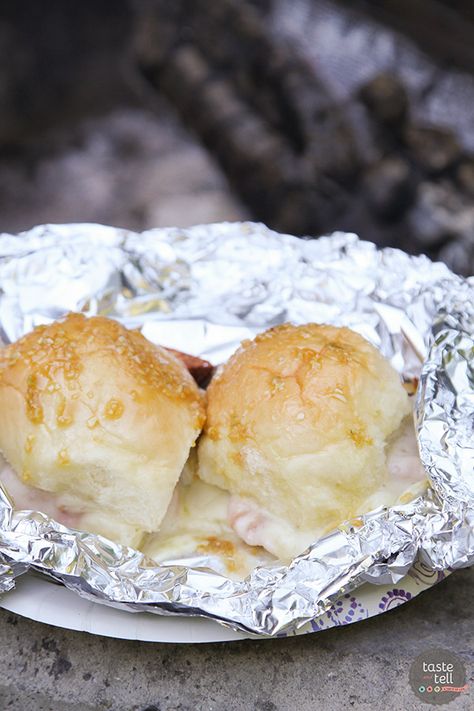 Campfire dinner in minutes! These Hot Ham and Cheese Campfire Sandwiches only take minutes to assemble. Throw them on the hot coals and dinner is done quickly and easily. Campfire Sandwiches, Tin Foil Meals, Easy Campfire Meals, Hot Ham And Cheese, Campfire Dinners, Cheap Camping, Foil Pack Dinners, Best Camping Meals, Camping Cabins