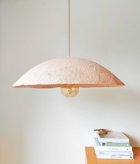 "\"Bettiloom is a unique brand of lighting fixtures that believes natural products in the home reflect care for our planet.\" The BettiLoom lights are made in a small studio in Slovenia by a family of five. In the production we are using recycled paper mixed with natural pigments and cellulosic, water based glue. All our products are completely manufactured by hand - crafted with a paper mache technique. The final presentation of Bettiloom products is raw, ascetic look. Each product is unique. P Paper Mache Lamp, Luminaria Diy, Natural Lamps, Minimalist Lamp, Diy Luminaire, Lampe Diy, Kitchen Lights, Lamp Pendant, Family Of Five