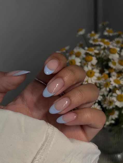 A hand with medium long nude nails painted with light blue French tips #womensfashion #naildesign #springnails #nails #naildesigntrends Spring Nails 2024 Trends French, Simple Almond Acrylic Nails, Blue Prom Nails, Ladybug Nails, Almond Acrylic, Blue French Tips, Light Blue Nails, Nude Nail Designs, Floral Nail Designs