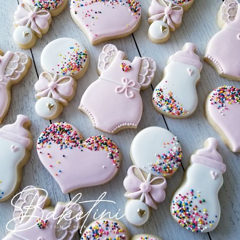 Sprinkled with Love!  Hand decorated in pink and white royal icing with sprinkle accents; these adorable cookies are the perfect treat for any baby shower or baby sprinkle party. Each 3"-4" cutout cookie is rolled to 3/8" thickness for the perfect cookie to icing ratio. Baked with the freshest ingredients these delicious vanilla, almond sugar cookies are sure to sweeten any day. BY THE DOZEN This listing includes ONE DOZEN (12) baked to order cookies individually packaged, heat sealed in certified food safe clear bags, then bubble wrapped and boxed for secure shipping. (3) Rompers  (3) Bottles (3) Rattles (3) Hearts Looking for something extra special?  Request a custom order here...  https://form.jotform.com/baketini/custom-cookie-request-form Food Allergy Warning: All goods produced by B Valentines Baby Shower Food, Baby Sprinkle Cookies Girl, Sprinkled With Love Cookies, Sprinkle Shower Favors, Pink Cookies Decorated, Baby Shower Sugar Cookies Girl, Baby Sprinkle Gift Ideas, Baby Sprinkle Cookies, Pink Baby Shower Cookies