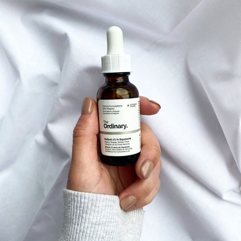 The Ordinary 1% Retinol in Squalane held with a hand with painted nails against a white cotton backdrop. Ordinary Skincare Aesthetic, Ordinary Aesthetic, Serum Aesthetic, Aesthetic Skincare Routine, Ordinary Retinol, The Ordinary Retinol, Oil Texture, Ordinary Skincare, Ultra Beauty