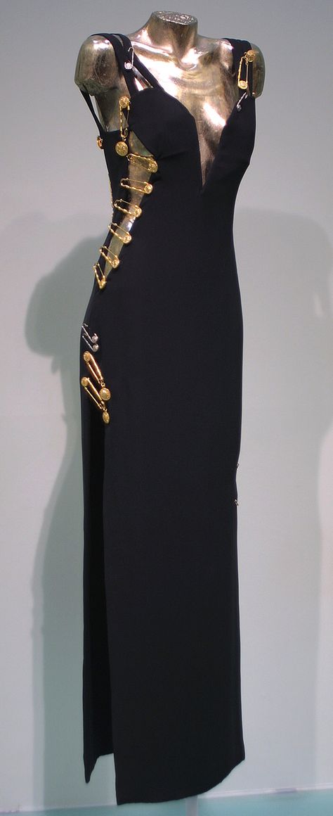 Evening gown worn by Elizabeth Hurley, Spring-Summer 1994, Versace, black viscose and acetate with kilt pin embellishments Versace Black Dress, Black Versace Dress, Vintage Versace Dress, Versace Aesthetic, Safety Pin Dress, Versace Safety Pin, Vestidos Versace, Pin Dress, Versace 90s