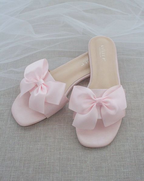 Classic slide flat sandals for casual and dressy look with added SATIN BOW. Simple and easy wear for brides, bridesmaids and wedding parties.DETAILS:COLORS AVAILABLE: Ivory, Light Blue, White, Pink, and ChampagneUPPER: Synthetic upper and liningMATERIALS: Mandmade outsole STYLE NAME: EVELYN