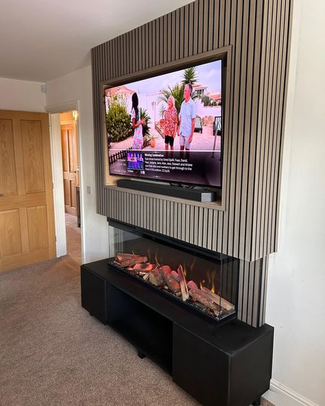 💎 Another of this week's media wall installations - this time featuring a standalone up-and-down build, a black base with cupboards for storage, our LUMIERE 1270mm electric mediawall fire, light wood slat, and a deep TV recess with room for a soundbar on the shelf. OUR SHOWROOM ✅ See before you buy ✅ Huge brick-and-mortar showroom ✅ 400+ fires and 60+ mediawalls on live display ✅ Specialist advice ✅ Showroom exclusive brands ❗️Pricing for mediawalls is bespoke to you, your needs and your bu... Recessed Tv Wall, False Wall, Wall Cupboard, Decor Fireplace, Living Room Decor Fireplace, Wood Fireplace, Media Wall, On Live, Slat Wall