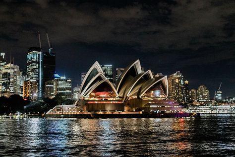 The classic Sydney Opera House is Sydney Australia. It's so beautiful lit up at night. | Asher Gardner Photography   #travelinspiration #sydneyoperahouse #sydneyaustrailia #travelaustrailia #exploreaustrailia Dark Asthetics, Travel Cities, Purple City, Olympic Village, Laptop Wallpapers, Cities Around The World, Big Cities, City Restaurants, Projection Mapping