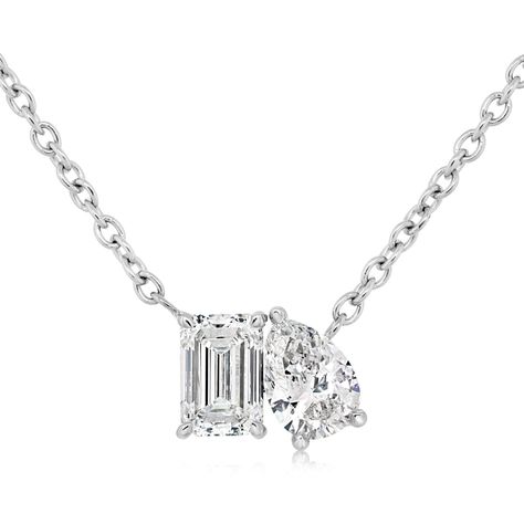 14K white gold diamond two stone diamond pendant from the Reis-Nichols Collection. The pendant features one emerald cut diamond and one pear shape diamond weighing .66 ctw. The necklace measures 16" in length. Emerald Cut Diamond, Pear Shaped Diamond, Emerald Cut Diamonds, Style Gift, Pear Shape, Emerald Cut, White Gold Diamonds, Diamond Pendant, Pear Shaped