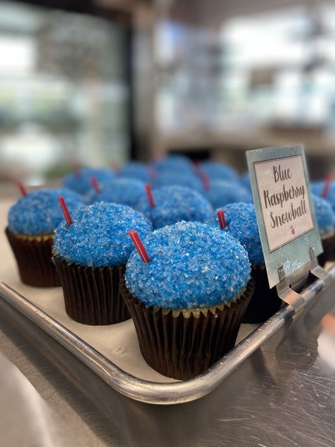 Fun Blue Raspberry Snowball cupcakes by Flavor Cupcakery. Vanilla cake, marshmallow fluff filling, blue raspberry-flavored buttercream frosting coated in blue sugar. Blue Raspberry Desserts, Jolly Rancher Cupcakes, Blue Raspberry Frosting, Blue Frosting Cupcakes, Blue Vanilla Cupcakes, Blue Raspberry Cake, Snowball Cupcakes, Blue Raspberry Flavored Things, Marshmallow Fluff Filling