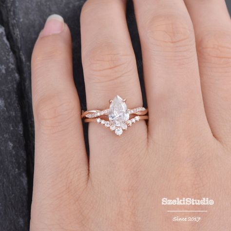 "Infinity Pear Shaped Moissanite Engagement Ring Rose Gold 6x9mm Twist Solitaire Moissanite Ring Diamond Half Eternity Ring Bridal Woman Interested in bridal set: https://www.etsy.com/listing/651183149 Same design with different gemstone: https://www.etsy.com/listing/609590330 https://www.etsy.com/listing/655314606 https://www.etsy.com/listing/654797976 ITEM INFORMATION Metal Type - Solid 14k Rose Gold Band Width - (approx. 2.3mm) Engagement Ring Center Stone - 6*9mm Moissanite, Pear Cut Clarity Pear Shaped Engagement Rings With Twisted Band, Pear Engagement Ring Twisted Band, Twist Engagement Rings With Wedding Band, Infinity Band Engagement Ring, Rose Gold Pear Engagement Ring, Gold Band Engagement Rings, Pear Moissanite Engagement Ring, Pear Wedding Ring, Rose Gold Ring Set