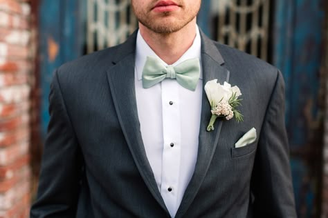 Grooms charcoal suit with mint bow tie and pocket square Sage And Charcoal Wedding, Sage Green Bowtie Groomsmen, Sage Bow Tie Groomsmen, Charcoal Suit Green Tie Wedding, Sage Bow Tie, Sage Green Pocket Square, Sage Green Bow Tie Groomsmen, Charcoal Suit Green Tie, Sage Green Bow Tie