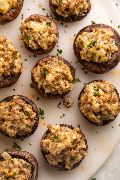 Pass a good time (and some good food) with these party-ready sausage stuffed mushrooms! Greet your guests with a tray of savory, creamy, bite-sized hors d'oeuvres that feel elegant and elevated, but are super easy to make. You might want to be ready with a second tray, though. They disappear fast! Stuffed Sausage Mushrooms, Sausage Mushroom Recipes, Nye Finger Foods, Sausage Stuffed Mushrooms Easy, Italian Stuffed Mushrooms, Stuffed Mushrooms Easy, Sausage Stuffed Mushrooms, Best Sausage, Stuffed Mushroom