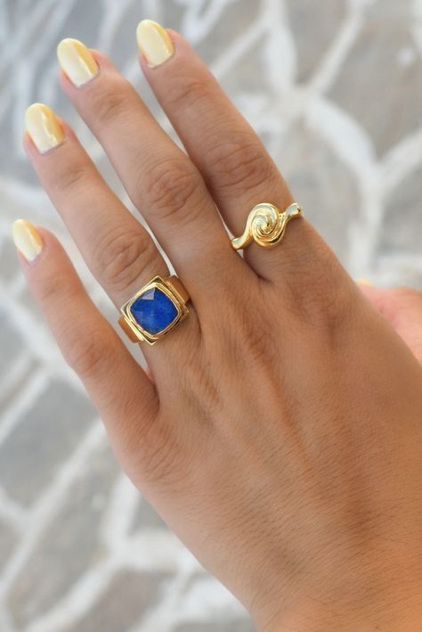 This Swirl Ring is crafted with intricate ancient Greek designs for a jewelry piece that's as eye-catching as it is timeless. Show off your unique style with this distinctive ring. Will you be next to rock this classic statement piece? INOOKU was established in 2016 and is based in central Athens. All INOOKU pieces are handmade, ethically and traditionally created with techniques inspired by the ancient Greeks. All pieces are handmade with attention to detail by highly skilled technicians, and t Greek Designs, Hand Rings, Greek Design, Lapis Ring, Swirl Ring, Lapis Blue, Greek Jewelry, Ring Stack, Right Hand Rings