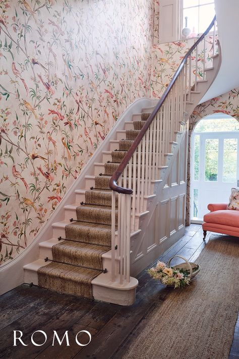 A pink floral wallpaper in a grand hallway. A pink armchair sits in the corner of the entrance hall. Wallpaper Stairwell, Romo Wallpaper, Romo Fabrics, Stair Wall, Hotel Chic, Blush Wallpaper, Modern Nautical, Stair Decor, Curved Staircase