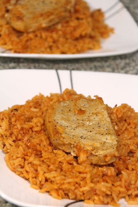 This Pork Chops and Rice recipe is delicious, comforting, and has been passed down through the family. Mexican Pork Chops And Rice, Pork Steak And Rice Recipes, Spanish Rice And Pork Chops, Pork Chops And Spanish Rice Recipe, Pork Chops And Rice In The Oven, Pork Chop And Rice Recipes, Spanish Pork Chops, Mexican Pork Chops, Cheesy Pork Chops