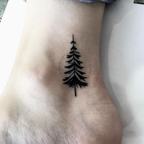 Black pine tree tattoo on the inner ankle - Tattoogrid.net Dotted Circle Tattoo, Tree Tattoo Ankle, Black Pine Tree, Dotted Circle, Tree Tattoo Back, Tattoo Ankle, Willow Tree Tattoos, Ankle Tat, Tattoo Tree