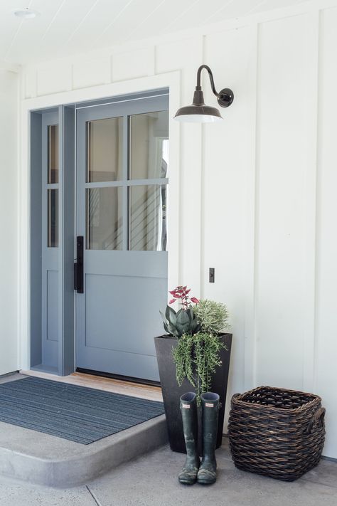 Modern Farmhouse entry door, blue door, white exterior, black barn light, entry door. Photo by Jennie Corti Modern Farmhouse Front Door, Blue Modern Farmhouse, Exterior Door Colors, Farmhouse Entry, Blue Front Door, Coastal Country, Front Door Paint Colors, Farmhouse Front Door, Farmhouse Doors