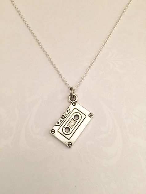 Awesome Cassette Tape Necklace- Antique Silver Plated - Beautiful, Simplistic, Unique, and pretty much down right AWESOME! Perfect for any music lover! Great gift for musicians, recording artists, music teachers, band members, Chorus members ... you name it! What a great statement on many different levels...For those of us that remember having to put a blank tape in to record our songs on the radio when they came on.. to make the best mix tapes ever....this necklace is for you! Includes: ●Casset Tape Music, Artists Music, Music Necklace, Gold Leaf Necklace, Music Teachers, Music Teacher Gifts, Floating Necklace, Bezel Necklace, Music Jewelry