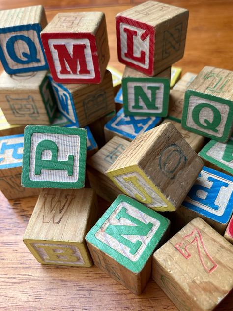 "Colorful vintage alphabet building blocks. Each block has 2 different letters painted on it in different colors. The letters are painted with primary colors, red, blue, yellow and green. Two sides have colourful letters, the other two sides have numbers and letters which appear to have been stamped on with blue or red ink.  Size: 1 1/4\" cubes Condition: Great vintage condition. These are vintage blocks and have been played with over the years. You can expect marks or discolorations and wear and tear. If you would like  a picture of the blocks you want before you place an order, just send me a message. I'd be glad to send you one.  Each block is $2.50 Lots of fun for birthday photos, new baby gifts, baby showers, anniversaries, gender reveals and maternity photos... even college and masco Ceramics Portfolio, Baby Building Blocks, Vintage Alphabet, Abc Blocks, Letter Blocks, Block Painting, Baby Letters, Diy Blocks, Kids Blocks