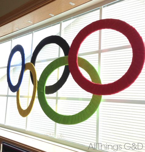 Winter Olympics Party - DIY Olympic Rings | www.allthingsgd.com Diy Olympics Decorations, How To Make Olympic Rings, Olympic Decorations Diy, Cathletics Vbs, Diy Olympic Rings, Winter Olympics Party, Vbs Olympics, Olympic Ring, Office Olympics