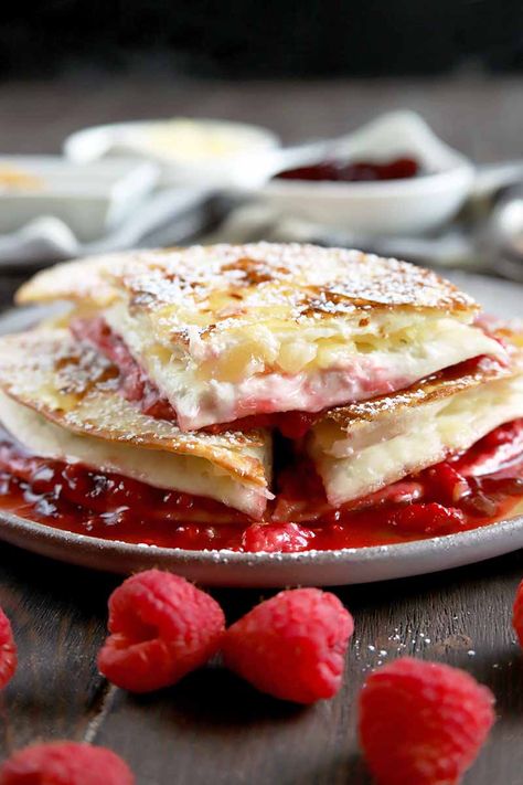 Think quesadillas are a savory treat just to be enjoyed for lunch or dinner? Think again! Our sweet raspberry, pineapple, and cream cheese version makes a delicious dessert. Get the recipe on Foodal. #quesadilla #dessert #foodal Sweet Quesadilla, Fruit Quesadilla, Dessert Quesadilla Recipes, Quesadilla Maker Recipes, Cream Cheese Raspberry, Dessert Quesadilla, American Meals, Quesadilla Recipes Easy, Bread Puddings