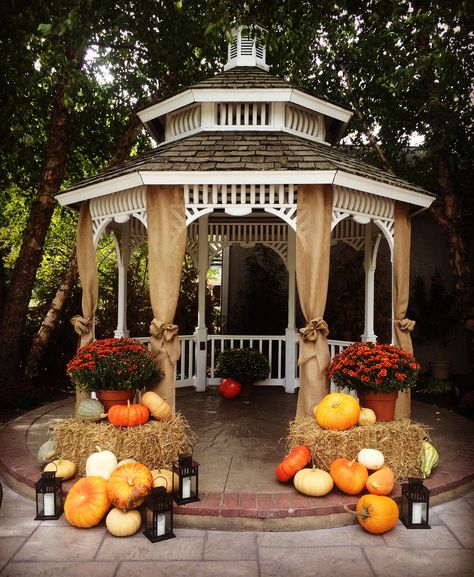 Fall decor for a outdoor wedding ceremony. Hay, lanterns, mums, & gourds. Fall Wedding Gazebo Decor, Fall Wedding Pavilion Decorations, Mums Wedding Bouquet, Gazebo Fall Decor, Wedding Gazebo Decorations Outdoor Fall, Pumpkin Patch Wedding Ideas, Gazebo Fall Wedding Decorations, Fall Wedding Lanterns, Fall Wedding With Pumpkins And Mums