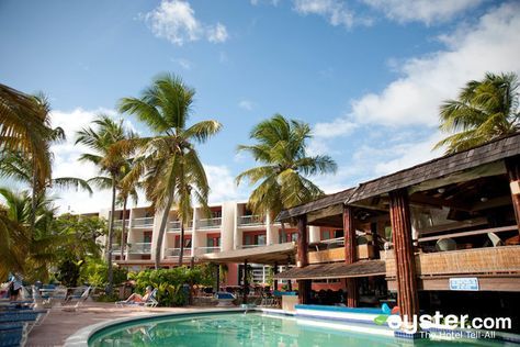 The mid-range Bolongo Bay Beach Resort, located in the southern part of St. Thomas, is a humble beachfront property that's popular for weddings, honeymooners, and families. The resort offers a nice selection of activities, and features include a wide, clean, soft sand beach with calm waters, a pool with a swim-up bar, and two open-air restaurants with a low-key beach bar vibe. The 74 rooms are bright and tropical, if a bit dated, with free Wi-Fi, mini-fridges, wet bars, and private balconies... St Thomas Vacation, Open Air Restaurant, All Inclusive Trips, Swim Up Bar, Wet Bars, Us Virgin Islands, Beachfront Property, Anniversary Trips, Beach Bars