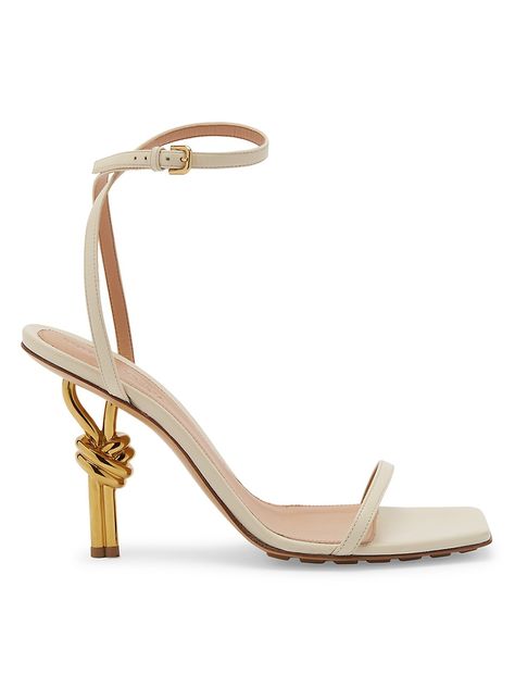 "Find BOTTEGA VENETA 90mm Knot Heel Leather Sandals on Editorialist. Crafted of soft lambskin, these Bottega Veneta heels are set on a goldtone knot heel. Open toe Adjustable buckle closure Leather upper Rubber/leather sole Made in Italy SIZE Knot heel: about 3.5\" (90mm) This brand fits slightly smaller. Consider ordering a size up. ABOUT THE BRAND Founded in 1966, the label known for fine Italian craftsmanship with creativity at its core has since catapulted to cult-level status. The house's s Bottega Veneta Heels, Bottega Veneta Shoes, White White, Sea Salt, Bottega Veneta, Saks Fifth, Saks Fifth Avenue, Leather Sandals, Open Toe