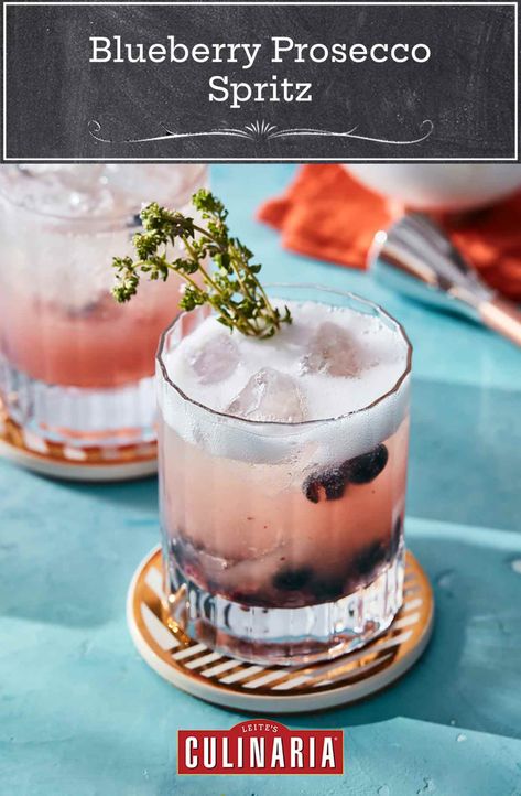 This blueberry Prosecco spritz is a low-ABV cocktail that's perfect for enjoying all summer long. Muddled fresh blueberries and thyme are combined with fresh lemon juice, sparkling wine, and tonic or soda in this easy, refreshing sipper. #lowabv #cocktail #proseccococktails #blueberrylemon Spritz Recipes, Cocktail Prosecco, Blueberry Cocktail, Cranberry Mimosa, Champagne Recipes Cocktails, Spritz Recipe, Citrus Vodka, Champagne Cocktails, Recipes For Summer