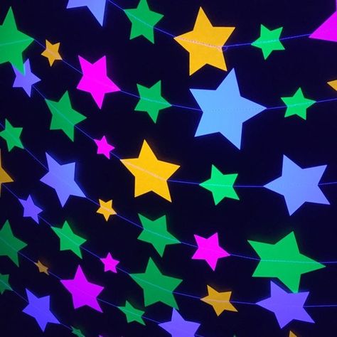 "These neon star garlands will light up your next glow party as they fluoresce under black light. Your kids (and all their friends) will think you are the coolest parent ever to have found such awesome decor! You won't believe the glow power of these colorful star garlands. This is a super fun and affordable way to dress up a black light/neon party. These multi-sized stars range in size from 4.5\" to 1\" and have been sewn together with strong, quality thread. They are so durable, you can use th Sweet 16 Glow Party, Rainbow Pics, Neon Stars, Glow In The Dark Party, Party Neon, Dark Party, Glow Stars, Aesthetic Ig, Neon Decor