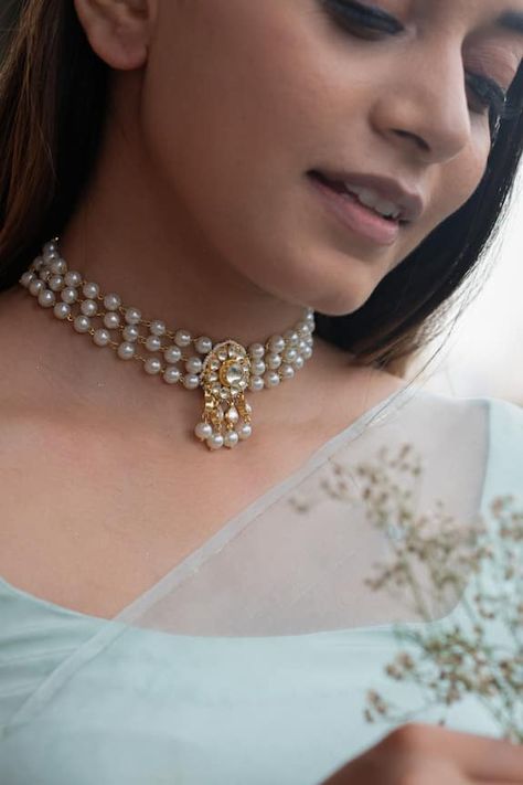 22k gold plated choker necklace features a kundan unit in the centre, highlighted with pearl details. Type: Pearls, Kundan Composition: Silver Alloy Color: Gold Other Details:  Triple layered Dimensions L x B (in inch): 14 x 1.70 Weight (in gms): 34 Closure: Lobster clasp - Aza Fashions Pearl Choker Indian Jewelry, Pearl Jewelry Choker, Pearl Traditional Jewellery, Gold Choker With Pearls, Layered Pearl Necklace Indian, Pearl Necklace Designs Indian, Beads Choker Necklace Indian, Pearls Necklace Indian, Pearl Choker Necklace Design