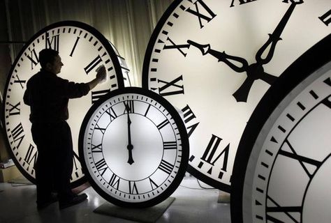 Electric Time Co. employee Walter Rodriguez cleans the face of an 84-inch Wegman clock at the plant in Medfield, Mass. Thursday, Oct. 30, 2008. Washington State lawmakers have proposed a bill that, if passed, could mean a change in time zones driving south to Seattle from Vancouver.  Elise Amendola/AP Clocks Forward, Large Clocks, Spring Ahead, Time Keeper, Daylight Savings, Time Clock, Daylight Savings Time, Working People, Pictures Of People