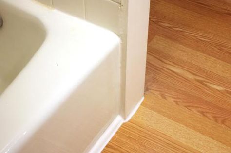 CottageBathroomTrimCaulk Tub Floor Trim, Bathtub Floor Trim, Rustic Remodel, Wood Floor Bathroom, Lodge Ideas, Green Tile Bathroom, Baseboard Trim, Handy Man, Floor Molding