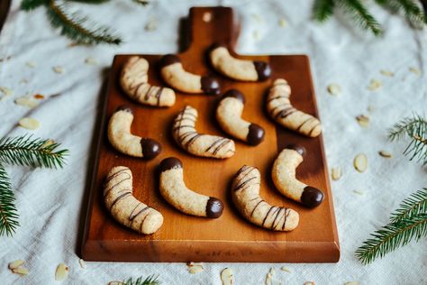 chocolate-dipped almond crescent cookies — the farmer's daughter Almond Crescent Cookies Recipes, Almond Crescent Cookies, Italian Almond Cookies, Crescent Cookies, Chocolate Dipped Cookies, Bake Something, Parchment Paper Baking, Dipped Cookies, Almond Cookies