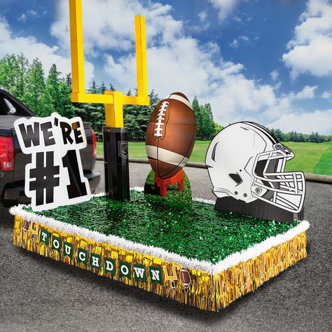 Score a touchdown with your parade float decorations! This easy kit provides a perfectly coordinated mix of decorative items to make your float the best one on the route. Use this convenient kit to put together a football themed parade float for your next parade. (14 pcs. per unit)Includes:o 1 Cardboard Football Helmet Stand-Up (51" x 44" Stand-ups are one-sided with brown cardboard backs. Simple assembly required.)o 1 Cardboard Football Stand-Up (31 1/2" x 56" Stand-upsa re one-sided with brown cardboard backs. Simple assembly required.)o 1 Cardstock Football Touchdown Garland (8 ft.)o 1 Cardboard Goal Post Stand-Up (Assembled, 54" x 12" x 96" Assembly required.)o 2 Vinyl Green Metallic Floral Sheeting (3 ft. x 15 ft.)o 1 Cardboard We're #1 Stand-Up (44" x 43" Stand-ups are one-sided with Football Homecoming Float, Football Parade Float Ideas, Football Floats Parade Ideas, Homecoming Parade Float Ideas Theme, Football Parade Float, Homecoming Parade Floats, Float Decorations Parade Diy, Hoco Float Ideas, Homecoming Float Ideas High School