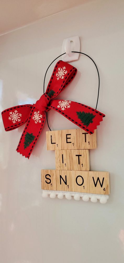 LET IT SNOW! LET IT SNOW! LET IT SNOW! Warm the hearts of your loved ones with this charming handmade ornament. A unique gift for the scrabble aficionado in your life- it's also perfect for secret santas, stocking stuffers, hostess gifts- anyone!  Every ornament is handmade to order using individual scrabble tiles that are backed in soft red velvet and hung with sturdy black wire. Adorned with pom poms and a big festive bow, you'll be sure to enjoy this unique gift for years to come! Your orname Christmas Scrabble Tile Crafts, Scrabble Ornaments Diy, Scrabble Tile Crafts Diy, Christmas Scrabble Tiles, Scrabble Tile Ornaments, Scrabble Christmas Ornaments, Scrabble Gifts, Scrabble Ornaments, Scrabble Tile Crafts