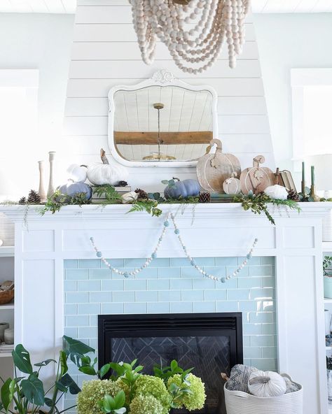 This white mantel is inset with aqua brick tile with white grouting. ItвЂ™s accented by a strand of white and aqua wooden beads decorating the mantel. The firebox itself features a black herringbone tile with white grout Harringbone Tile, Blue Herringbone Tile, Black Herringbone Tile, Fireplace Tile Ideas, Stone Electric Fireplace, Grey Stone Fireplace, Blue Bathroom Walls, Carved Stone Fireplace, Coastal Fireplace