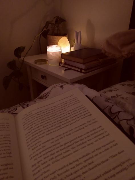 Book open in a bed in the semi darkness with salt lamp and candle burning in the background. Cozy room inspo Aesthetic Candles, Luxury Bedding, Sleep, Candles