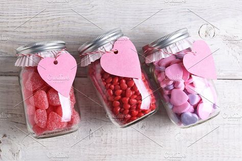 #Valentines Day Candy Jars  Canning jars laying on their sides filled with candy hearts and for Valentine's Day on a rustic wood table. The jars have blank heart shaped gift tags hanging from the neck. Rustic Wood Table, Valentines Day Candy, Candy Hearts, Candy Chocolate, Chocolate Decorations, Paper Cupcake, Blog Images, Cupcake Liners, Jar Gifts