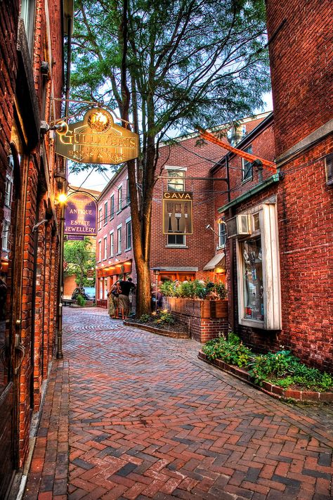 Commercial Alley splits Penhallow St. and Market Street in downtown Portsmouth, NH.  This shot taking early in the evening has three of Portsmouth’s hanging signs.  For a night shot of the sc… England Coast, Cobblestone Street, Portsmouth Nh, Beaux Villages, Destination Voyage, Samhain, Portsmouth, Pretty Places, Dream Destinations