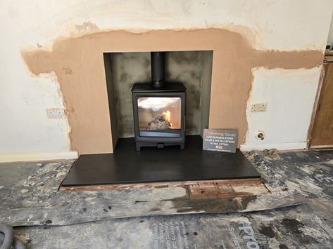 Fireplace modification and Firecracker wood-burning stove installation in Taunton, Somerset. This Fireplace modification requires raising the height to 950mm and widening the chamber to 900mm.  We knockout the fireplace opening to give plenty of space for the new log burner. We also remove the old tiled hearth. A wood burning stove performs more efficiently with space around it. It also looks far more aesthetically p #Fireplacealterations #logburner Tiled Hearth, Modern Log Burners, Log Burner Fireplace, Taunton Somerset, Stove Installation, Fireplace Logs, Open Fireplace, Combustion Chamber, Renewable Sources Of Energy