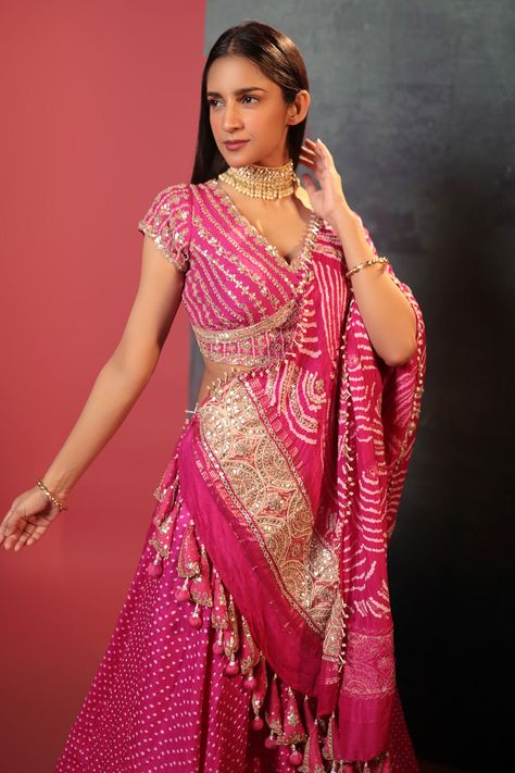 Buy Pink Silk Woven Bandhani V Neck Dotted Pattern Lehenga Set For Women by Bandhani Online at Aza Fashions. Anarkali Dress Bandhani, Pink Bandhani Lehenga, Bandini Blouses Designs, Embroidery On Bandhani, Bandhani Blouse Pattern, Bandhani Blouse Work, Bandhani Blouse Design, Bandhani Blouse, Bandhani Lehenga