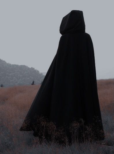 Cursing 101: How to break a curse | witchcraft for beginners and beginner witchcraft spells to know Hooded Cloak Aesthetic, Mysterious Cloaked Character, Fantasy Cloak Aesthetic, Headless Aesthetic, Cloaked Figure Aesthetic, Black Cloak Aesthetic, Curse Witchcraft, Cloak Aesthetic, Cape Aesthetic