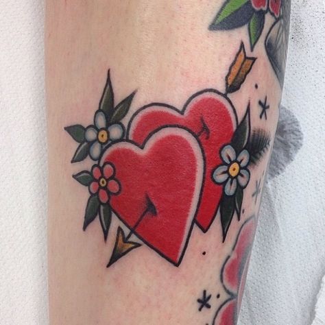 Two hearts stabbed with an arrow tattooed on the leg Heart Arrow Tattoo Traditional, Valentines Day Traditional Tattoo Flash, American Traditional Heart Tattoo, Heart And Arrow Tattoo, Heart Tattoo Traditional, Traditional Heart Tattoo, Valentines Tattoo, Heart Arrow Tattoo, France Tattoo