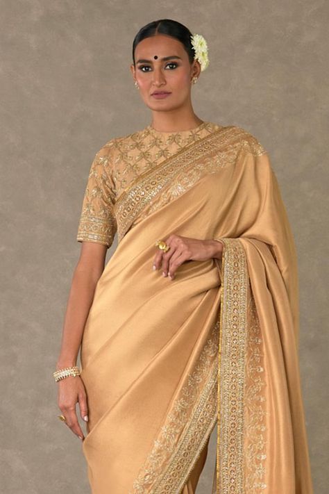 Beige saree adorned with madakal-chidiya border in pita, dori, sitara and dabka kaam embroidery. Comes with embroidered blouse with jaal, chidiya motif in pita, dori, sitara and dabka kaam. Components: 2 Pattern: Embroidered Type Of Work: Pita, dori, sitara and dabka Neckline: Zero Neck Sleeve Type: Short Fabric: Dupion silk Color: Beige Other Details:  Back cutout blouse Closure: Blouse: Back hooks Note: Plain blouse worn by the model is not for sale Disclaimer: The actual print-placement and c Zero Neck Saree Blouse, Beige Saree, Cutout Blouse, Neck Designs For Suits, Plain Blouse, Dupion Silk, Blouse For Women, Work Sarees, Print Placement